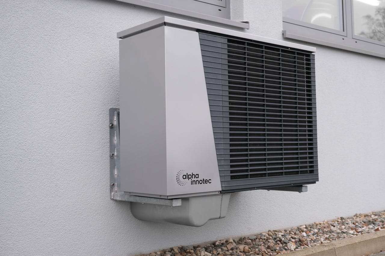 services-03 Outdoor air conditioning unit mounted on a residential building exterior.